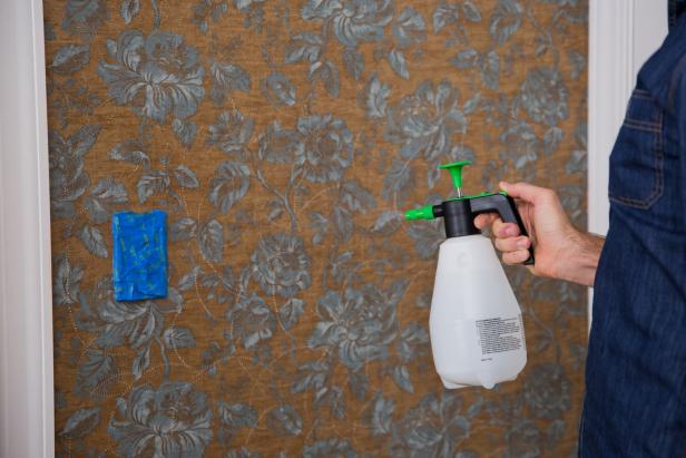 Use your pressure sprayer to apply a hot water solution to a four-foot-wide section of the wall. Wait for two to three minutes to allow the solution to work its magic.