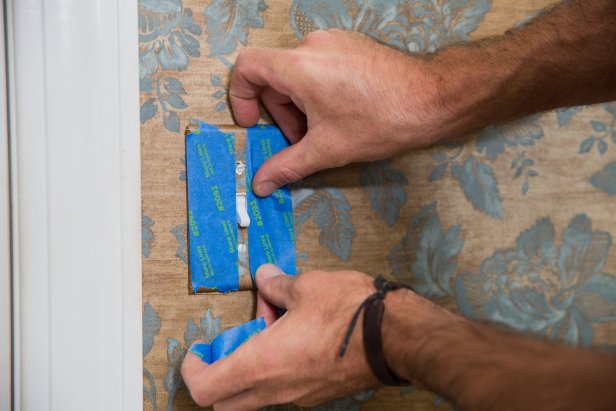 Your wall will probably have at least one electrical outlet; leave the outlet cover on and protect both the outlet and cover from spray by completely covering them with painter’s tape.