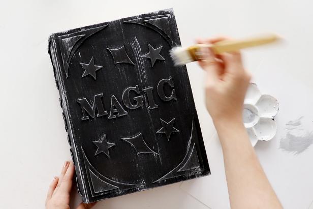 Use a stiff paintbrush to gently sweep silver paint onto the front of the book box to create depth and an aged look.