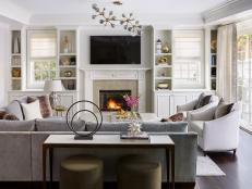 Living Room With Modern Light, Dark Sofa and Symmetrical Built-Ins