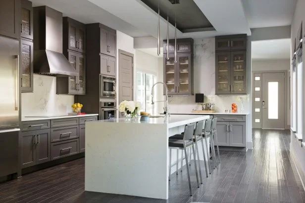 Dark Modern Kitchen With Waterfall Edge Kitchen Island and Four Seats
