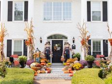 Cornstalks tied to pillars and posts create visual appeal by adding height and texture to a front porch. Use heavy-duty zip ties to hold cornstalks to your posts, then cover the ties with craft store ribbon. Add individual stems of fall leaves, tucked in behind the ribbon and zip ties, for additional color. 