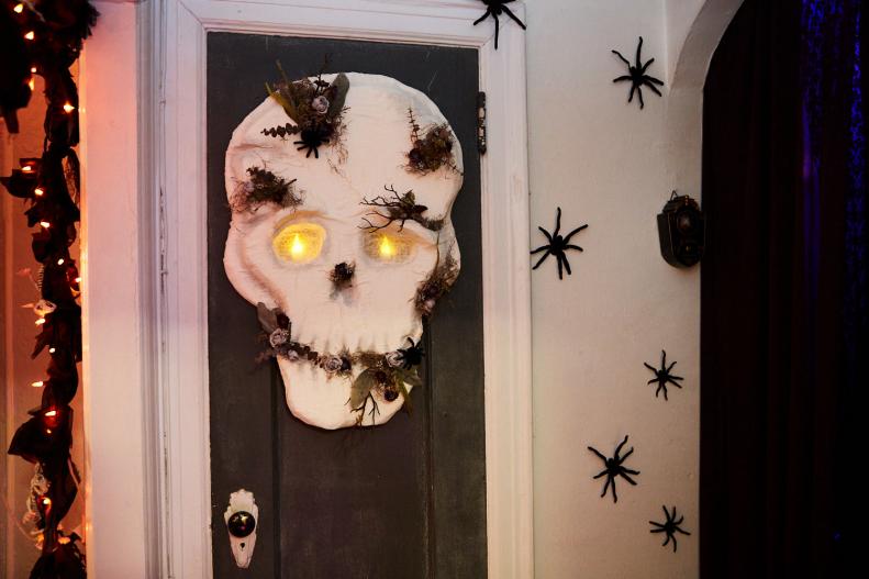 Crafty Lumberjacks' DIY Halloween skull decoration on their door
