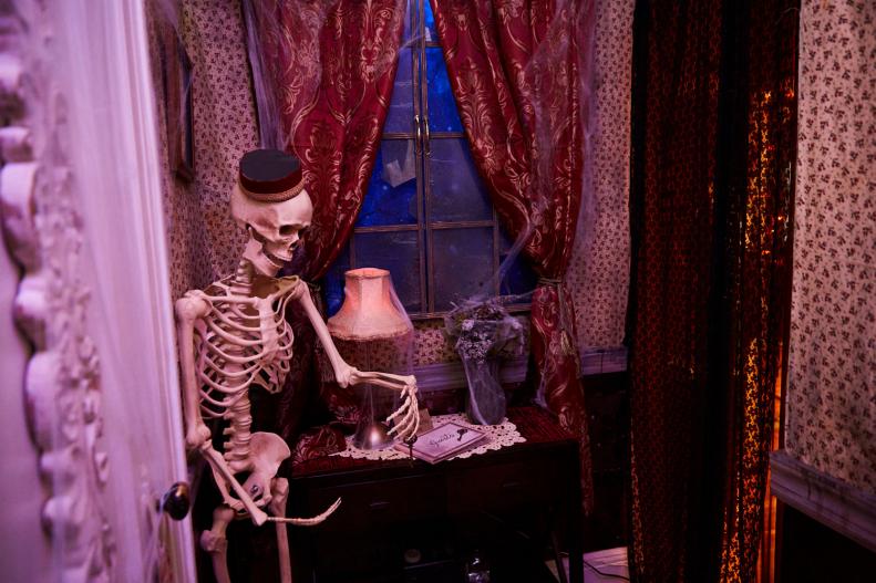 Skeleton "bellhop" as part of a haunted hotel Halloween decor theme.