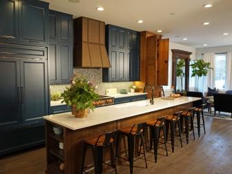 Alison Victoria, host of Windy City Rehab, incorporated custom blue caninets, elevated copper finishes and a coordinating penny round backspalsh into the kitchen of this historic Chicago home.