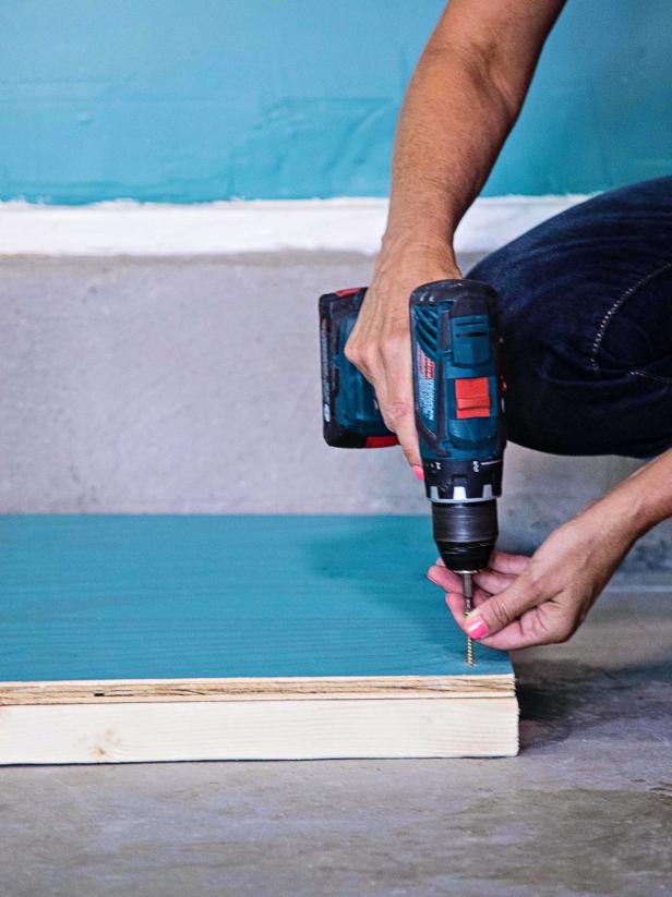 Then, cut one ½” plywood sheet to 3x8. Optionally, paint the plywood to match the rest of the unit. Use wood screws to secure the sheet to the 2x4s.