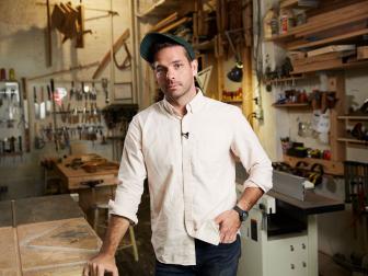 Jason Pickens poses in his Brooklyn studio surrounded by tools