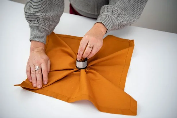Wow your guests with this cute pumpkin-shaped napkin.