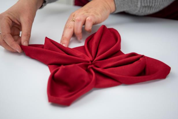 Impress your guests this holiday season with a poinsettia napkin.