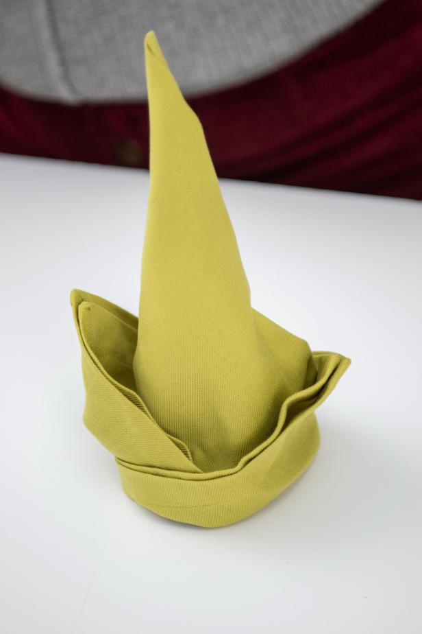 For extra cheer this Christmas, fold your table napkins into adorable little elf hats.