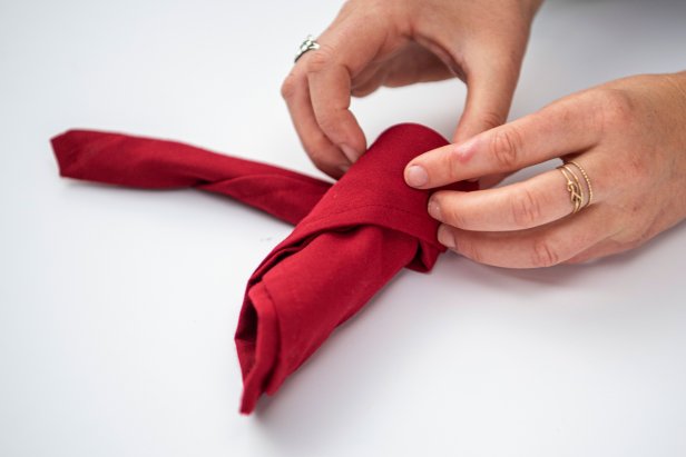 This folded napkin rose is sure to impress your guests this holiday season.