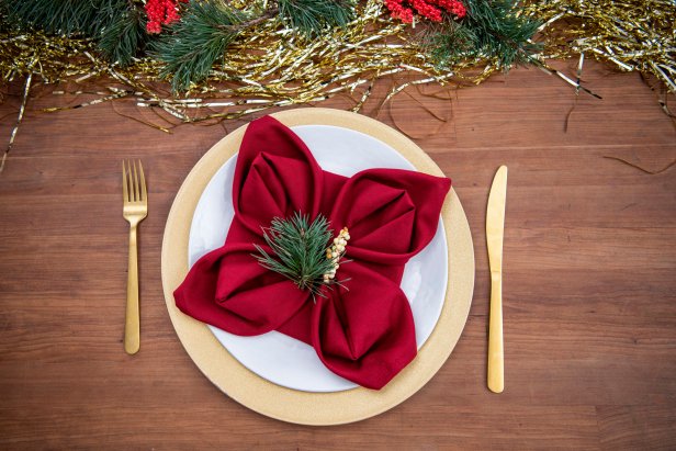 Red Napkin on Plate Folded With Four Points