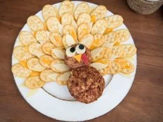 Overhead View of Cheese Ball With Crackers Arranged Like Feathers