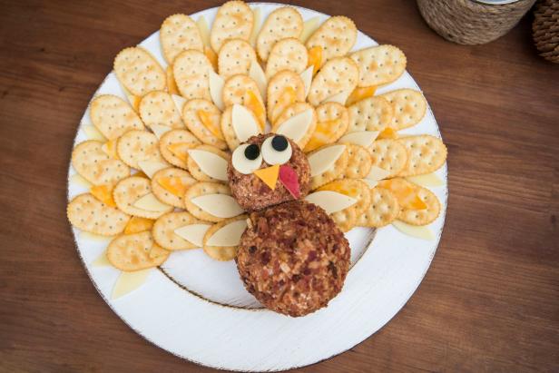 Overhead View of Cheese Ball With Crackers Arranged Like Feathers