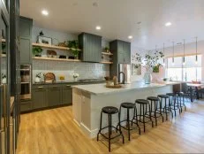 Neutral Kitchen with White Tile Backsplash and Green Cabinets 