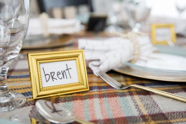 A Table With a Placeholder Card in a Gold Frame