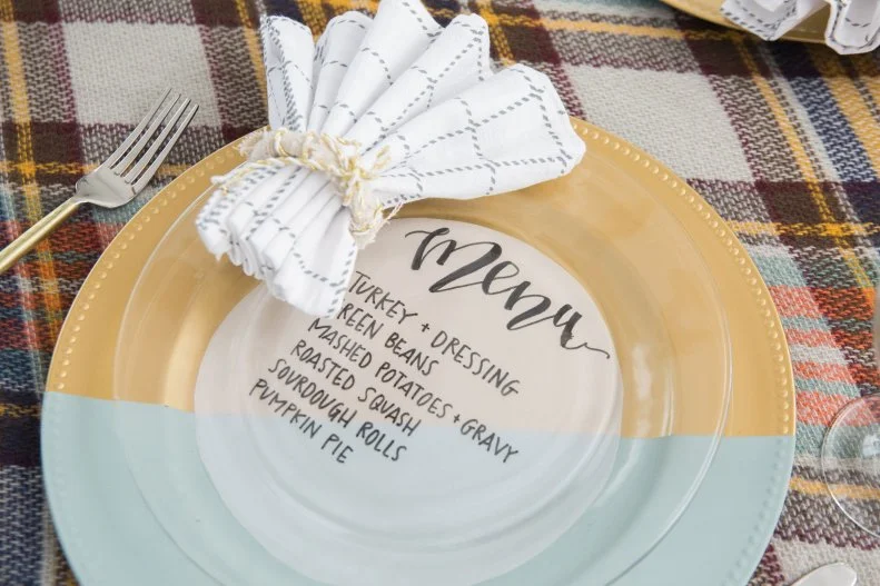 A Menu Printed on Vellum Paper On a Gold Charger