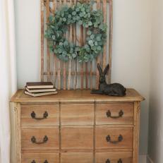 Wreath and Rabbit Sculpture Decorate Wood Dresser