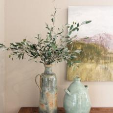 Pair of Vases and Plant Atop Table