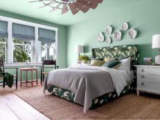 Neutral Rug Anchors Bed in Green Tropical Bedroom