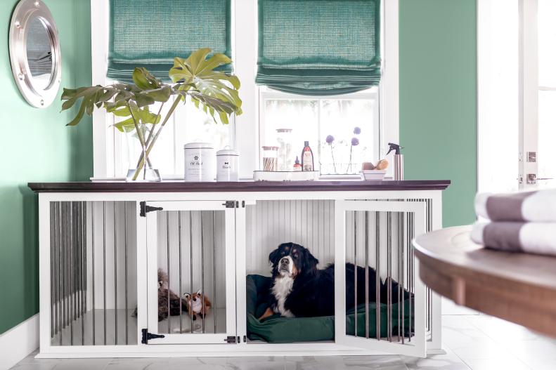 This laundry room and mudroom includes this double wide ventilated pet crate outfitted with a comfy dog bed and pet toys that gives the furry members of the family a comfortable spot for lounging. “If you’re someone who has a pet that needs to be put away during entertaining time, it’s super-friendly because there’s a lot of room for them to move around,” says designer Brian Patrick Flynn.