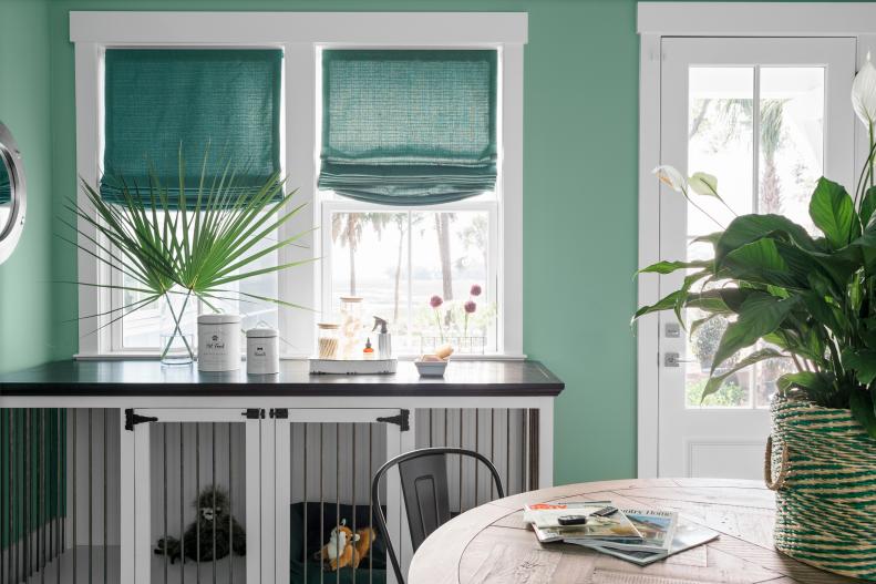 Large Pet Crate Beneath Windows With Roman Shades in Green Mudroom
