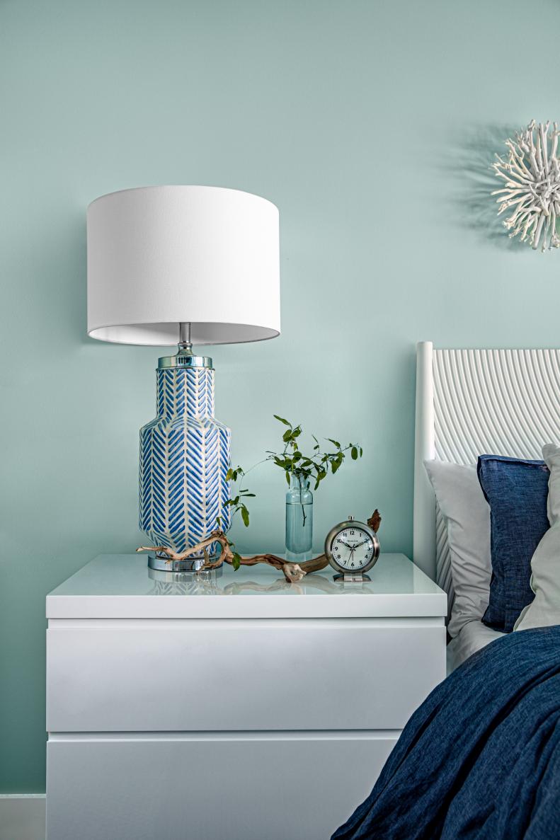 White Dresser Nightstand Topped With Blue-and-White Lamp