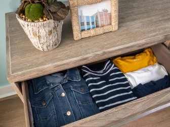 Clothes Neatly Folded in Open Wood Dresser Drawer