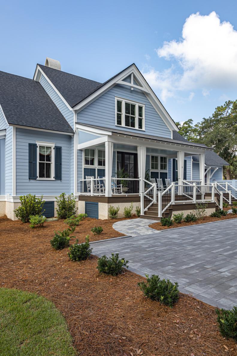 Blue Coastal Home Has Stone-Paver Driveway and Walkway