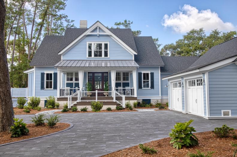 This timeless style home and detached garage were given a distinctive look. “The exterior stands out from most of the houses here because it’s painted a really calming shade of blue, with navy-blue shutters, all white trim and a charcoal shingle roof,” says designer Brian Patrick Flynn.