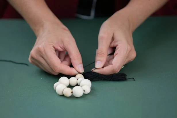 Make a chic, tasseled napkin ring this holiday season with wooden craft beads.