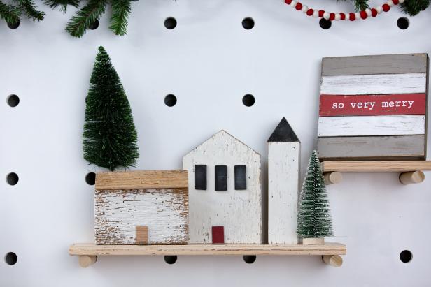 Three Wood Houses Sitting on Shelf