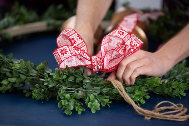 Add a bow at the top of the wreath to hide the knot of the bells.