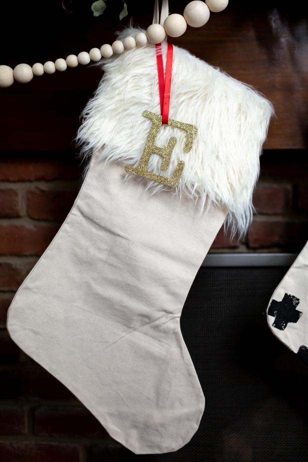 Stocking With Faux Fur Hanging From Mantel With Glitter Initial "E"