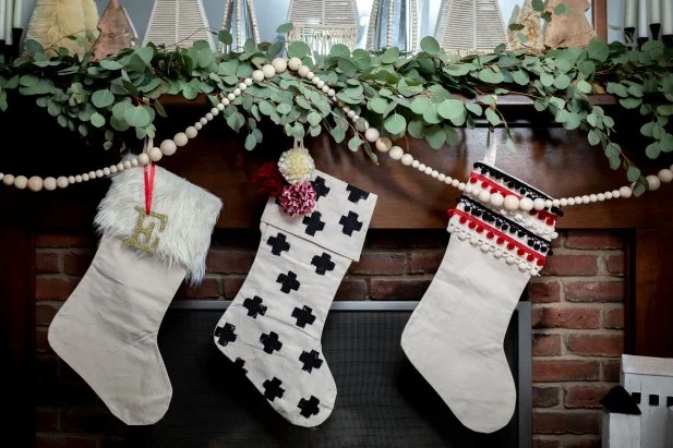Three Christmas Stockings Hanging From Mantel 