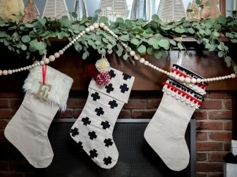 Three Christmas Stockings Hanging From Mantel 