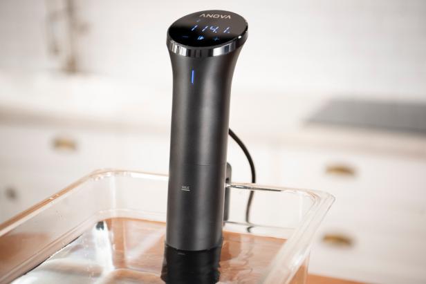 Sous Vide wand in water bath in kitchen