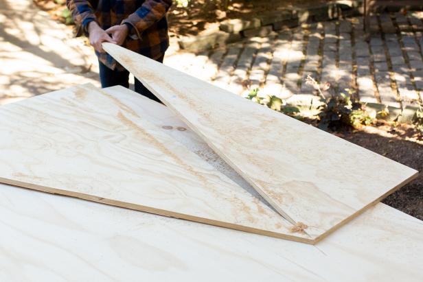 The triangular pieces of plywood will be assembled standing upright to resemble a tree.