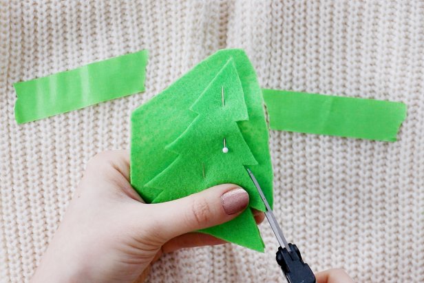 Embellish a plain white sweater with festive Christmas tree elbow pads for the holidays.