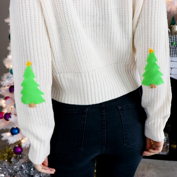 Woman Wearing Sweater With Christmas Tree-Shaped Patches on Sleeves 