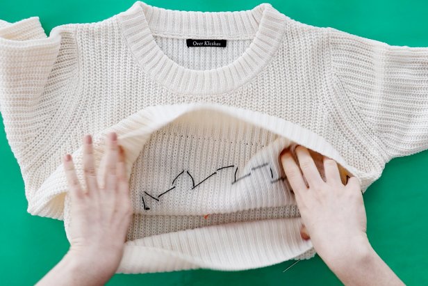 Embellish a plain white sweater with a couple pieces of felt to make a cute snowman sweater for the holidays.