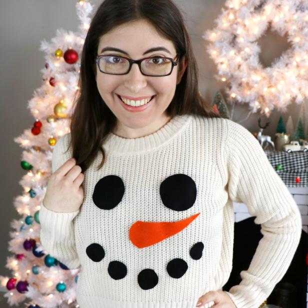Woman Wearing Sweater With Felt Snowman Face 