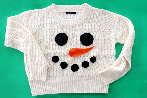 Embellish a plain white sweater with a couple pieces of felt to make a cute snowman sweater for the holidays.