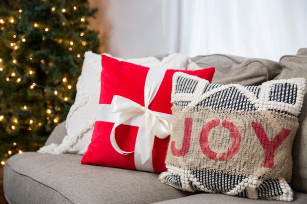 Two Holiday Throw Pillows Sitting on a Sofa