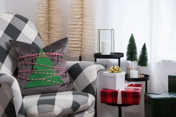 A Gray Throw Pillow Wrapped With a Felt Christmas Tree