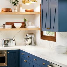 Open Kitchen Shelves and Brass Sconces