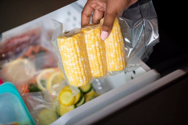 Placing vacuum sealed vegetables in freezer