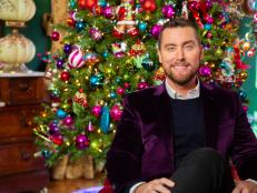 Host Lance Bass poses for a portrait in the heavily decorated guest room, as seen on Outrageous Holiday Houses.