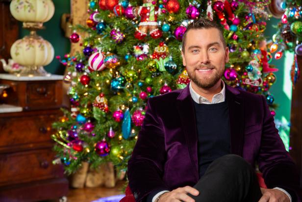 Host Lance Bass poses for a portrait in the heavily decorated guest room, as seen on Outrageous Holiday Houses.