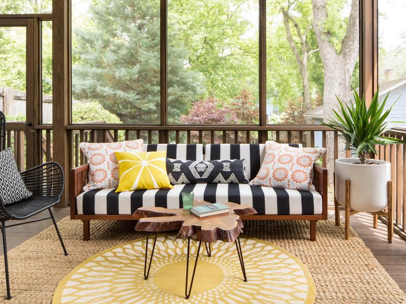 The original plan was to do a deck off the kitchen, but at the last minute, James got the idea to make it a screened porch. No bugs here! With a striped outdoor sofa from CB2, a wood-slice coffee table from World Market and a sunny round rug from Frontgate, it’s a chic continuation of their living space — and the family’s go-to spot for watching movies with a projector.